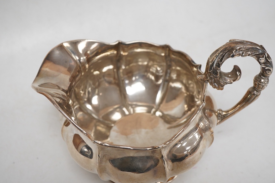 A George IV silver cream jug, with engraved monogram, by William, Charles and Henry Eley, London, 1824, height 10.5cm, 7.7oz.